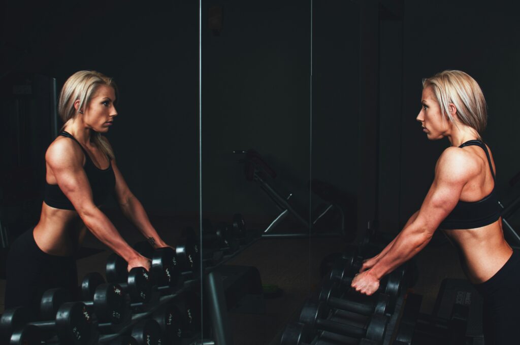 woman looking in mirror exercising mind body connection for mental health